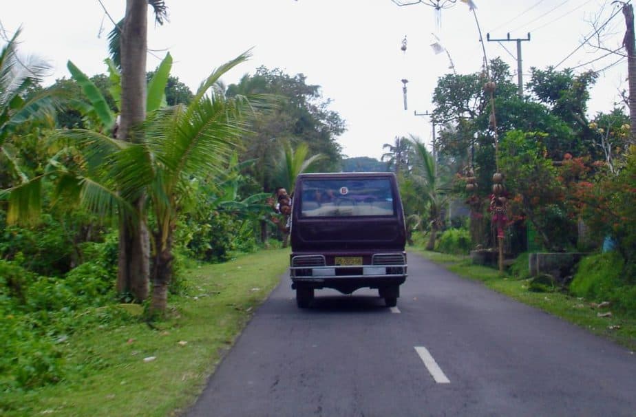 kids waiving from a Balinese bemo mini-van