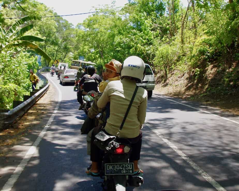 Balinese couple with their toddler on a motor scooter