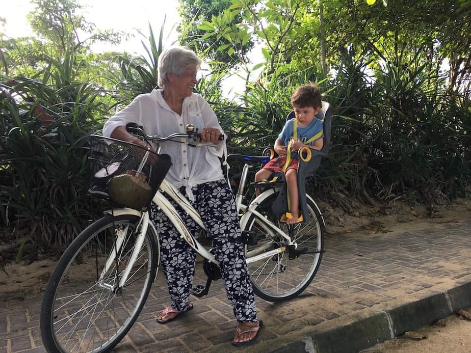 grandmother with her grandson on a bicycle in Sanur village