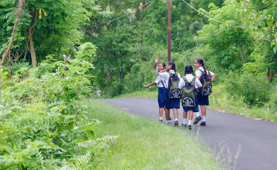 school children walking back from school in bali 