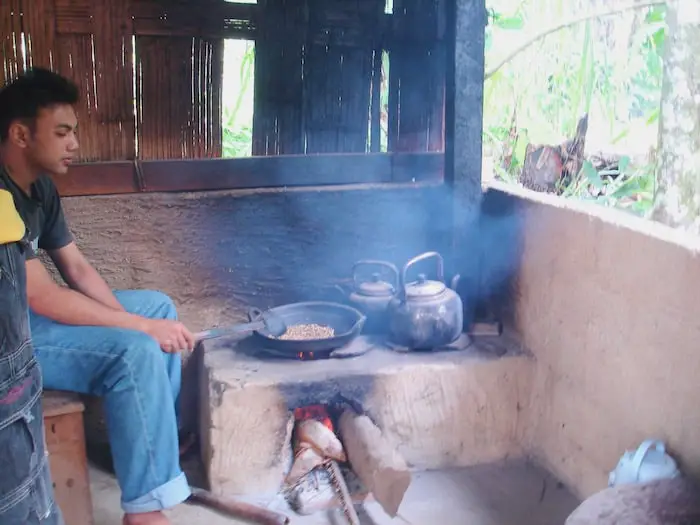 Balinese man roasting coffee beans