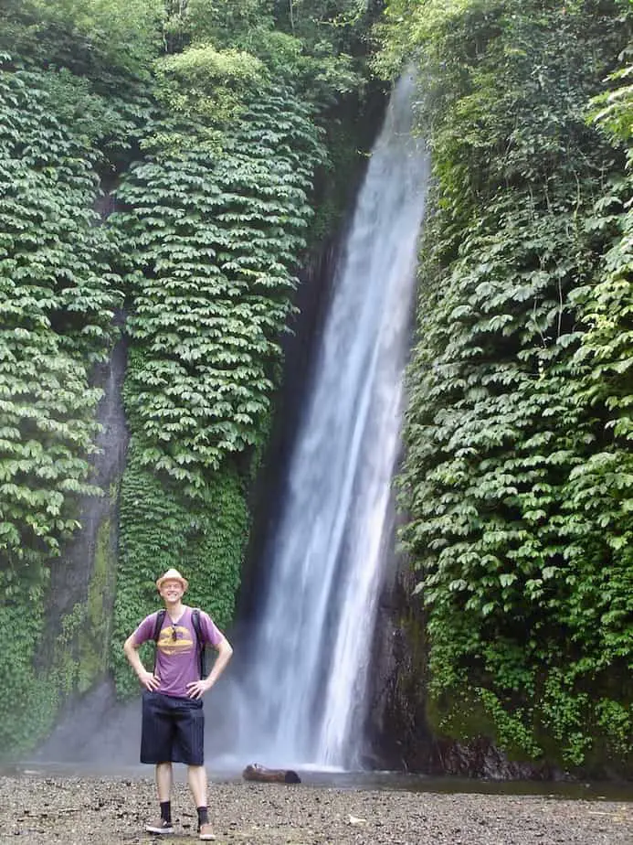standing in front of one of the waterfalls in Munduk village