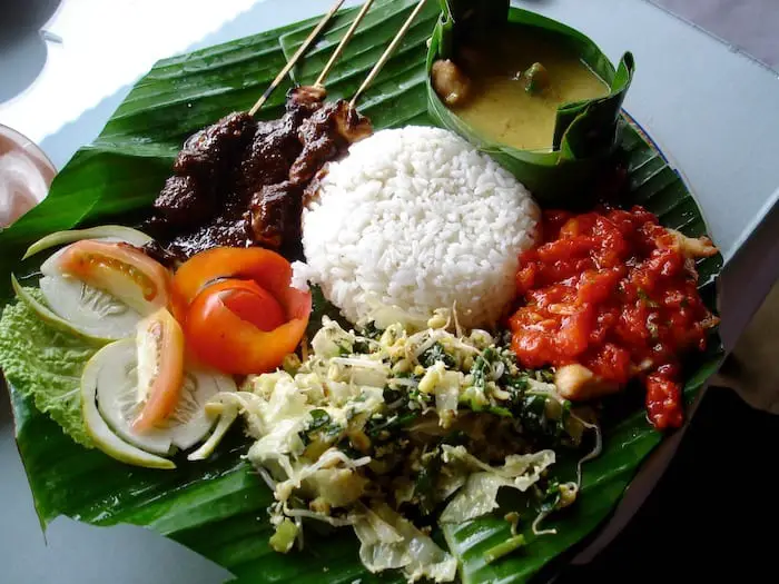 nasi campur served on a banana leave in Bali