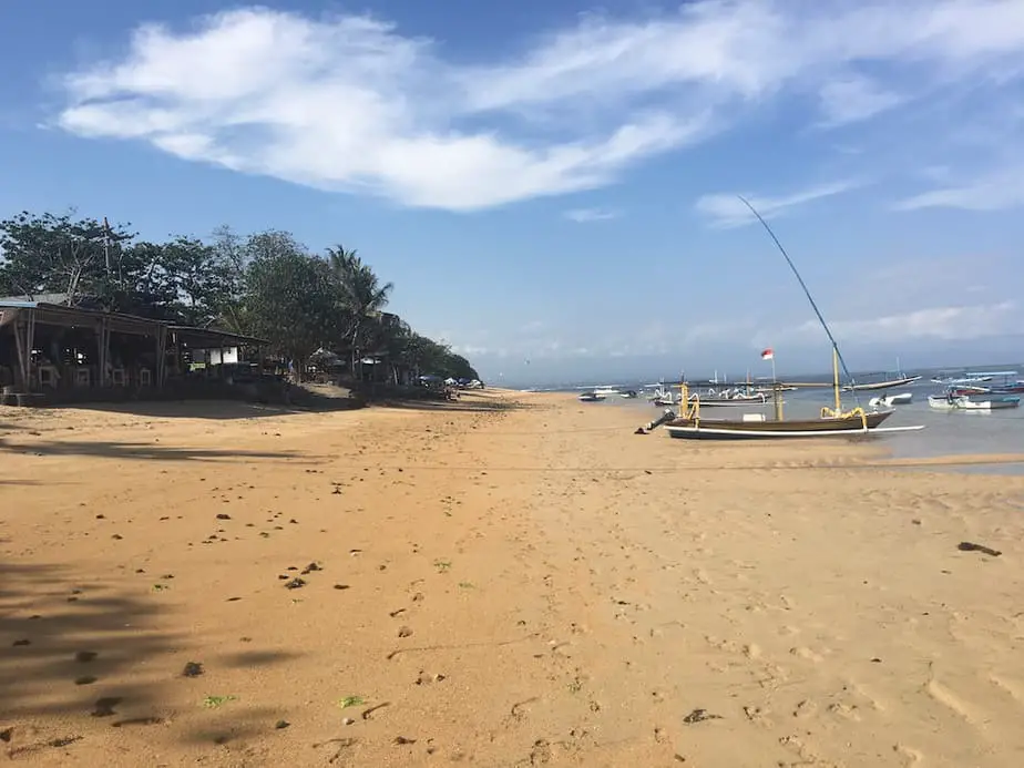 boats on Sanur beach during low-tide