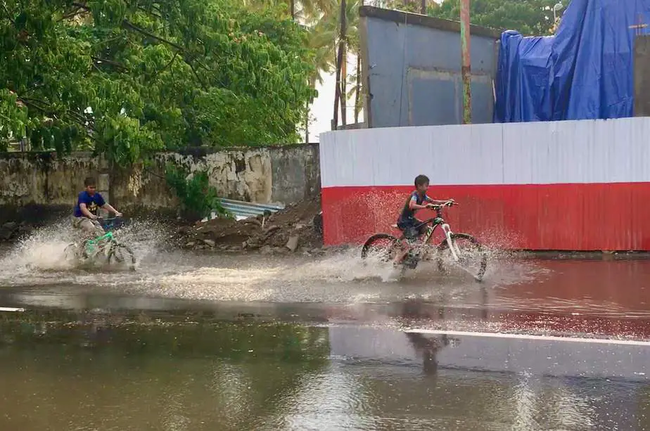 flooded streets where Indonesian kids play with their bicycles