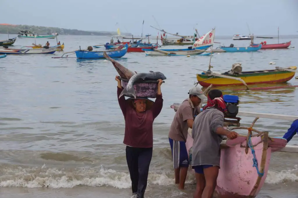 Balinese woman carrying fish to the Jimbaran Fish Market