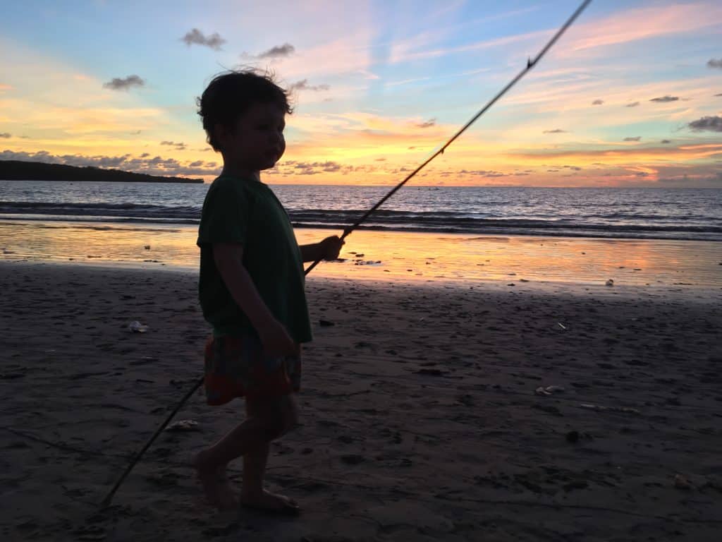 our little boy walking on the beach during sunset in Jimbaran Bay