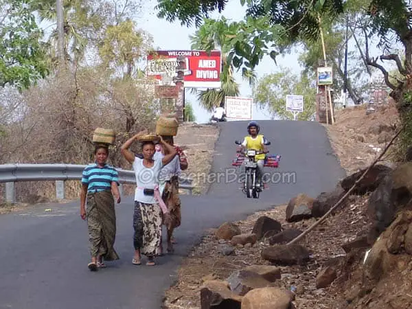 balinese woman walking in amed