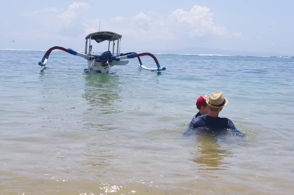 father and son floating at the beach in bali