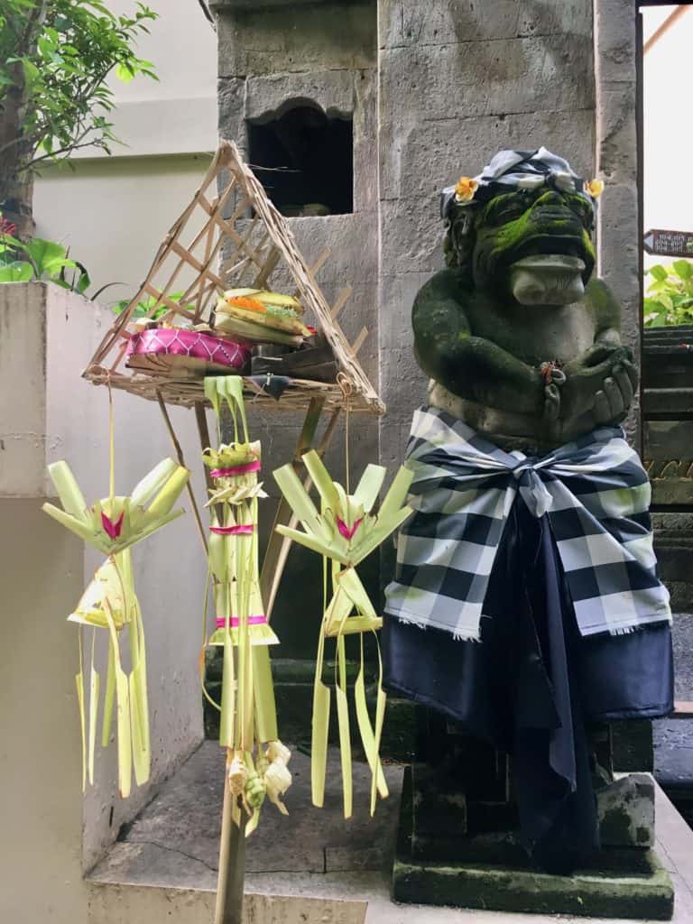 balinese statue with offerings