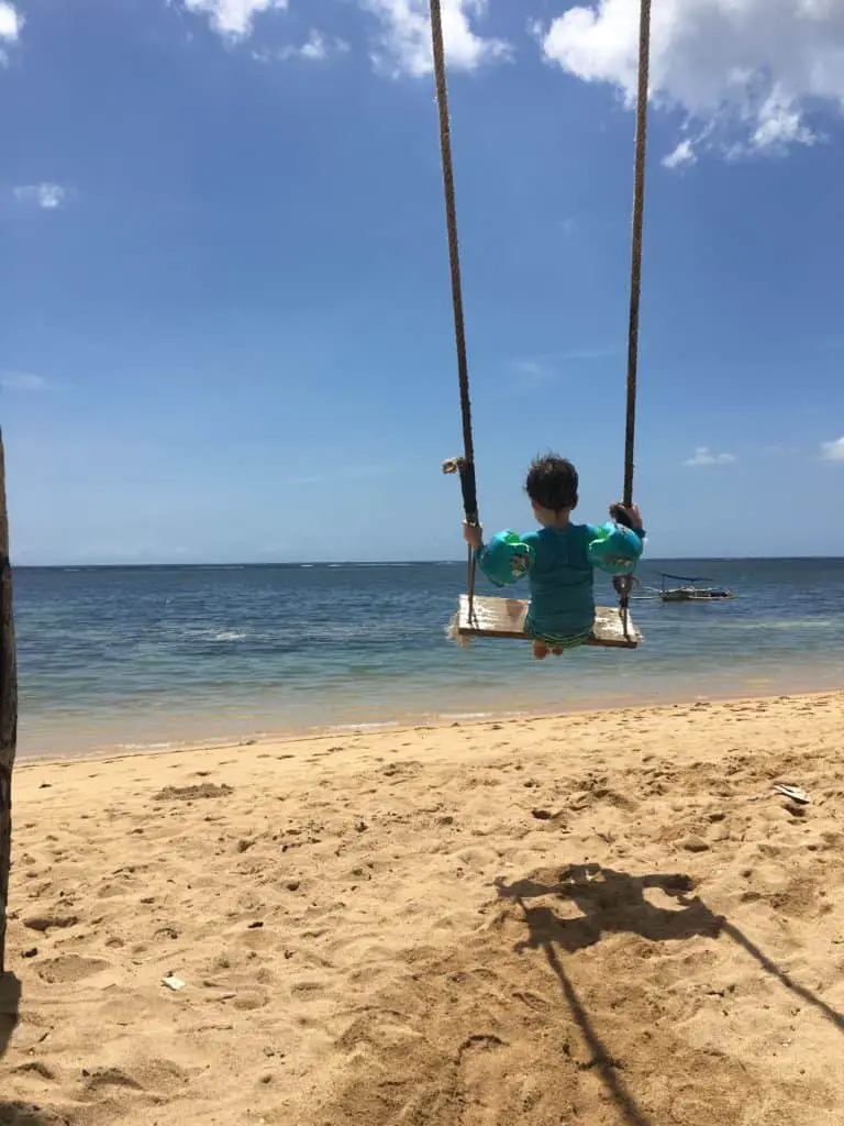 a swing on the beach in bali