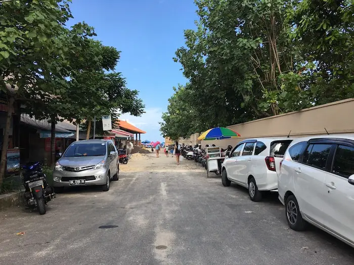 parking lot for cars and motorbikes at the beginning of geger beach