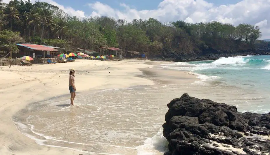 dipping our toes in the sand at Bias Tugel Beach in Padangbai
