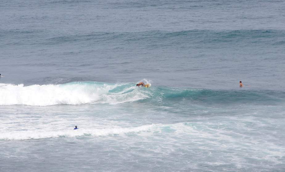 catching waves at Uluwatu Beach