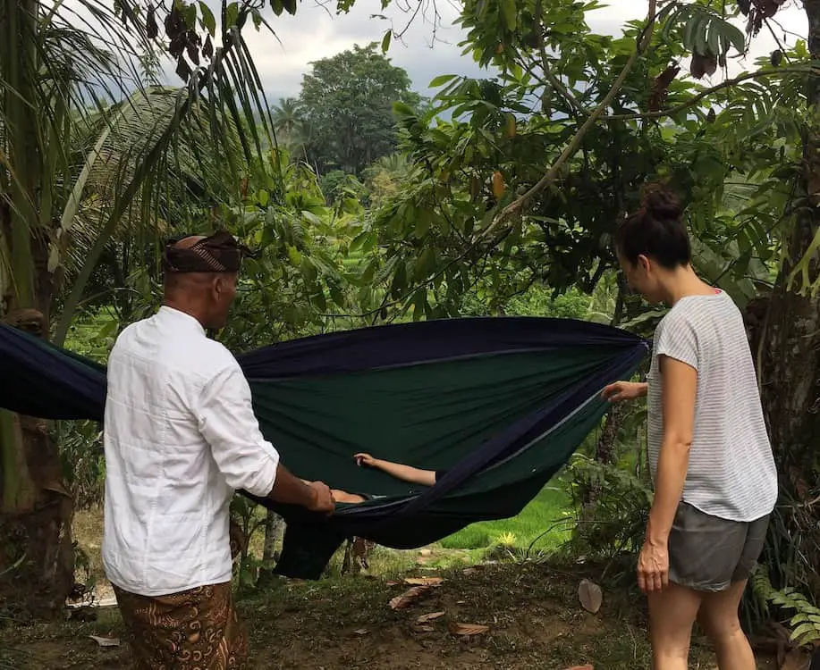 our little son in the hammock playing with Pak Made at Sari Devi Ecolodge in Bali