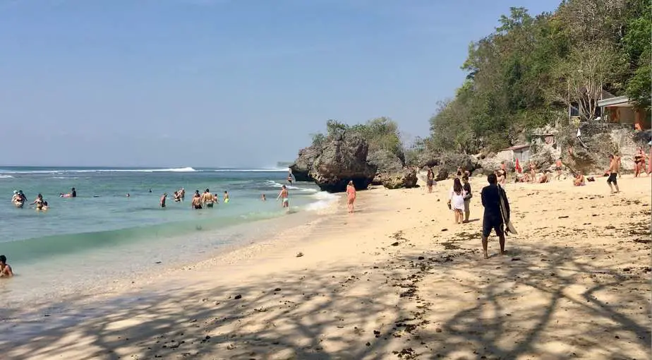 visitors swimming at Padang Padang Beach in Bali