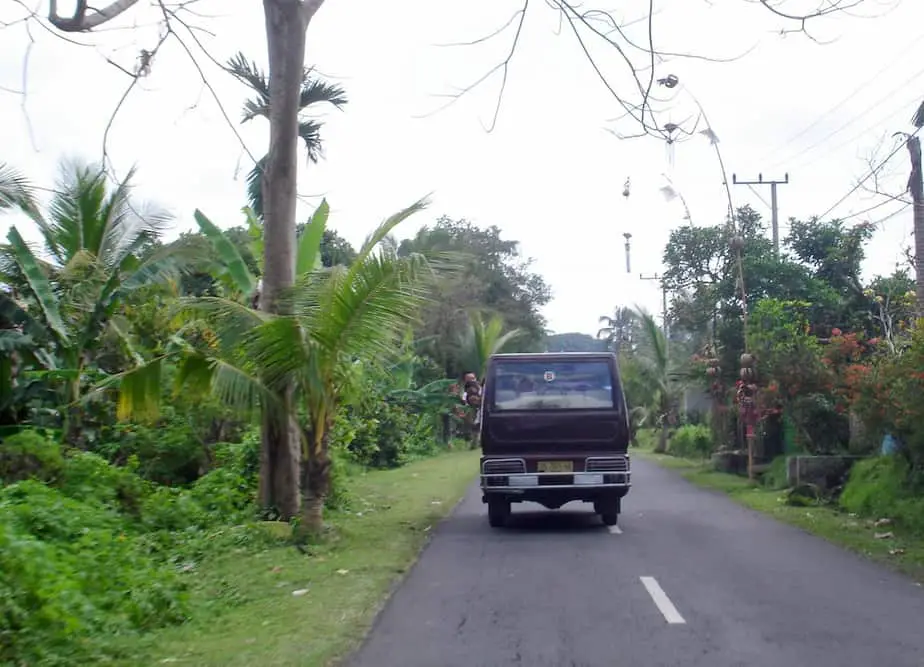 balinese kids waving from a school bus