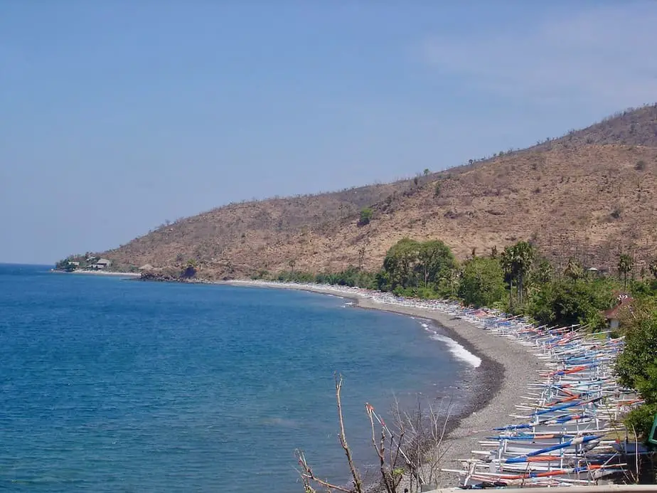 colorful fishing boats are lining the shore at Amed Beach