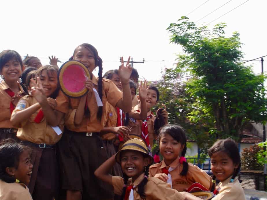 Balinese kids waving and saying hi to us from a truck in West Bali