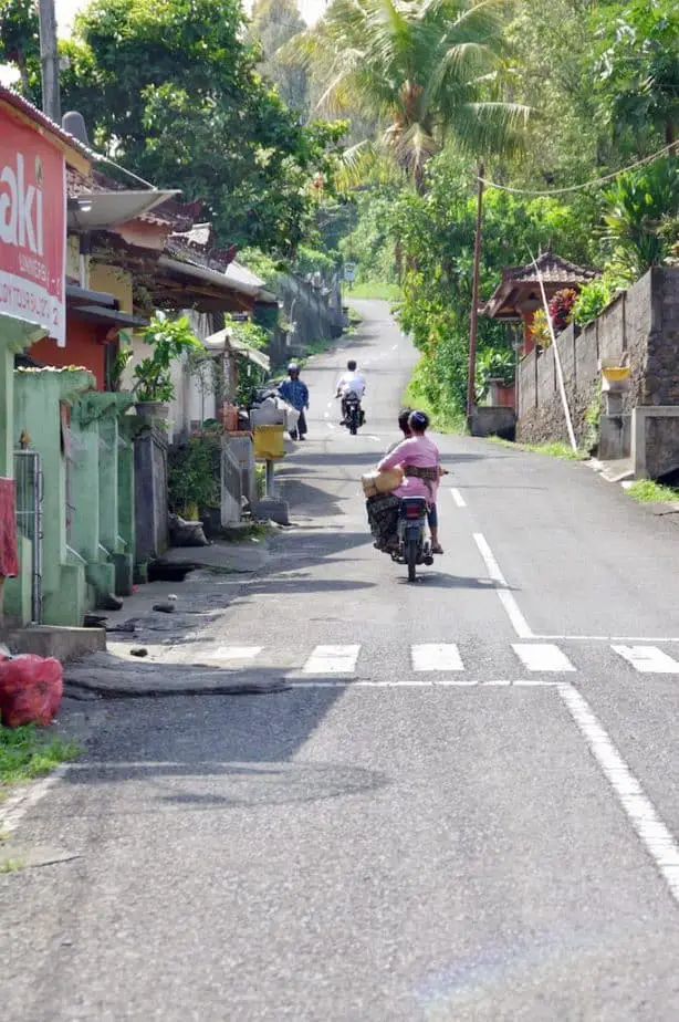 most Balinese people don't use helmets on the motor bike when they visit the temple