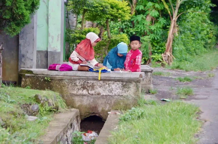 Balinese kids doing their homework outside