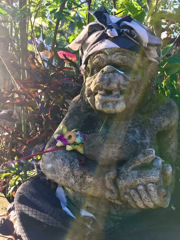 guardian statue with offerings in Bali